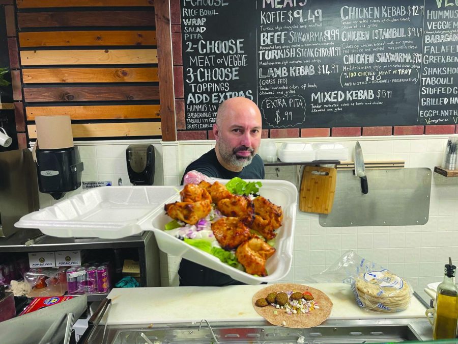 Chef G prepares chicken kebabs for a to-go order at Troy Grille on March 19. Troy Grille won third place for best vegan and vegetarian dining.