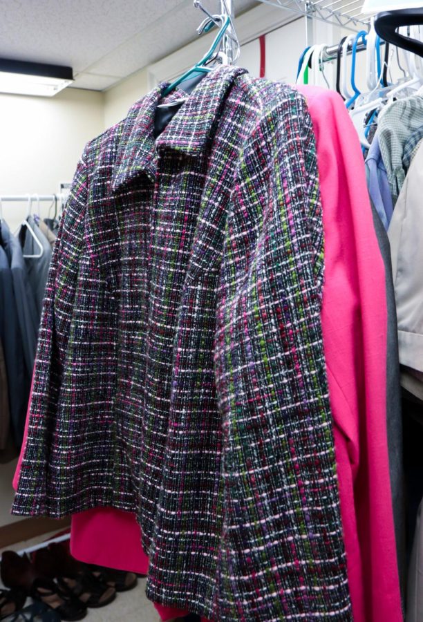 A detailed green and pink jacket in the career closet in the women's center at Kent State University.