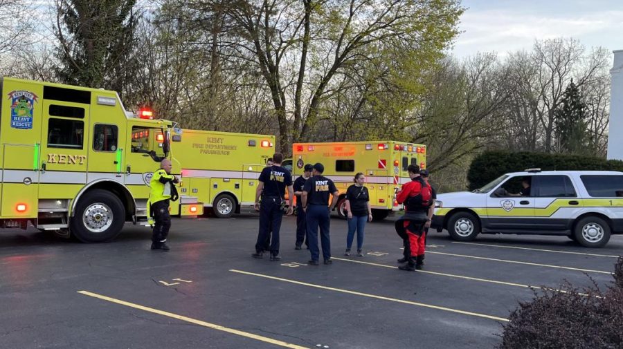 Darren Bade speaks with members of the Kent Fire Department after aiding in a rescue mission on Saturday, April 23, 2022.  Bade, an associate professor at Kent State, was kayaking on Saturday when locals alerted him to a mother and daughter drowning further down the river. Bade helped the pair find land and waited with them until the fire department arrived. 