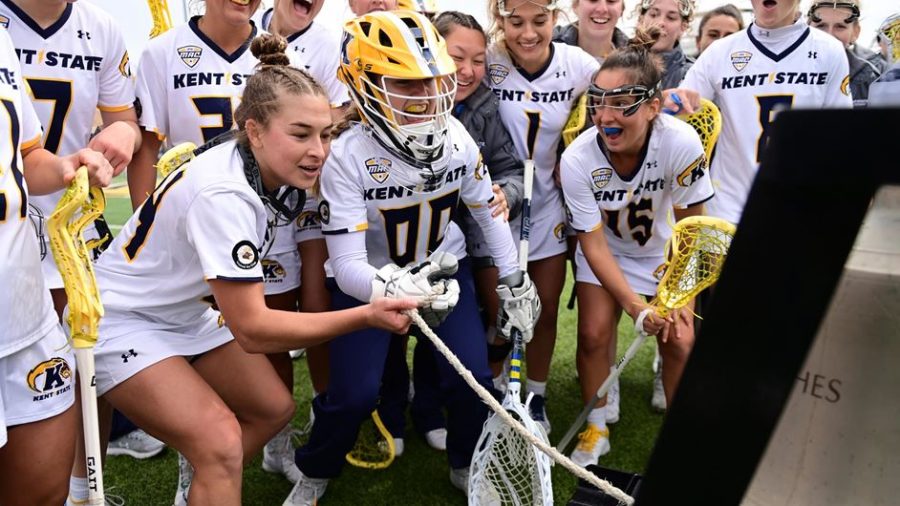 Members of the Kent State lacrosse team celebrate after defeating Akron in Kent, Ohio on Saturday, April 2