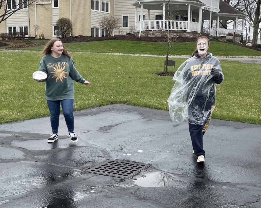 Junior fashion merchandising major Katelyn Pepper is "pied" by her sorority sister, senior early childhood education major Rachel Siemer.