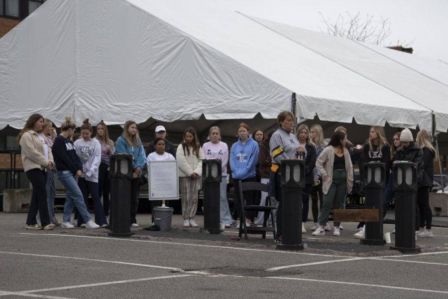 Members of Alpha Xi Delta sorority surround Sandra Lee Scheuer's marker during events on May 4. Kent State University Professor Margie Lagulli stands in the marker to commemorate Sandra. 