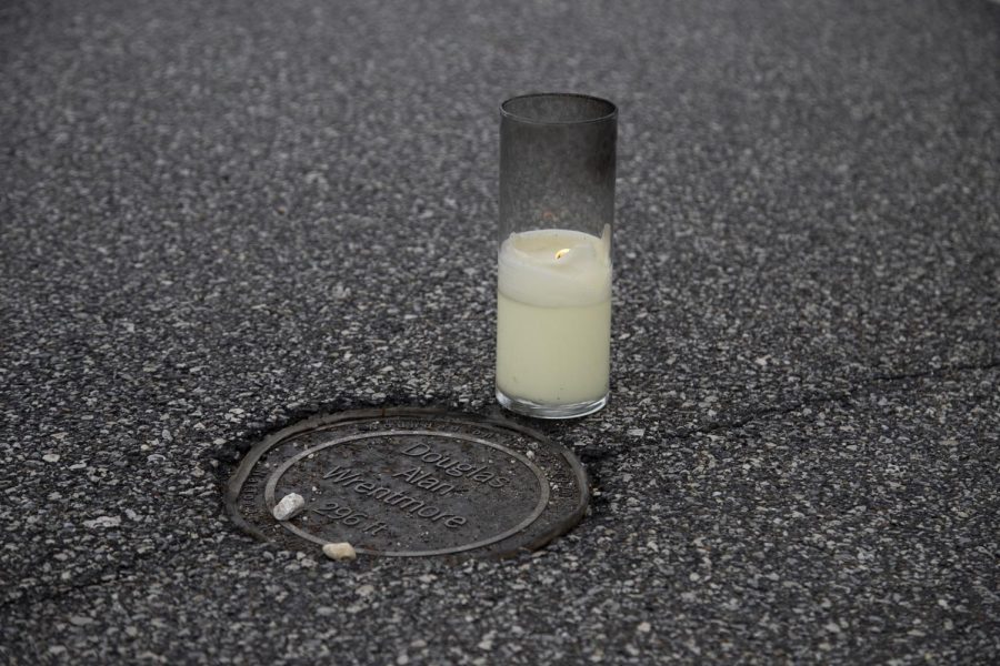 A candle was placed next to Douglas Alan Wrentmore's marker of where he was shot during the May 4 shooting at Kent State University. 