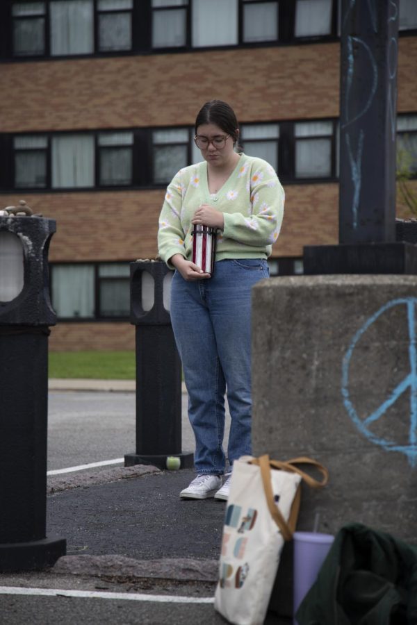 Senior speech pathology and audiology major Meghan Williamson stands vigil in Allison Krause's memorial in the Prentice Hall parking lot on May 4. 