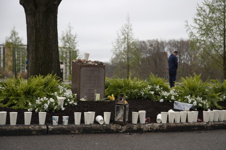 Candles left from the vigil surround the memorial stone made for those who died during the Kent State shooting on May 4, 1970.