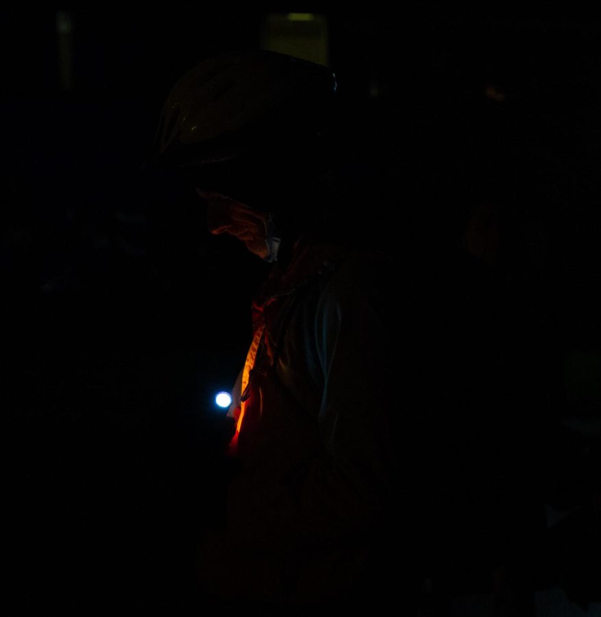 Joseph holds a candle in honor of the fallen and wounded at the May 4 candlelight vigil in the morning of Wednesday, May 4. He said he is a cyclist who saw the film "Fire in the Heartland" on TV, and that something led him to the vigil.