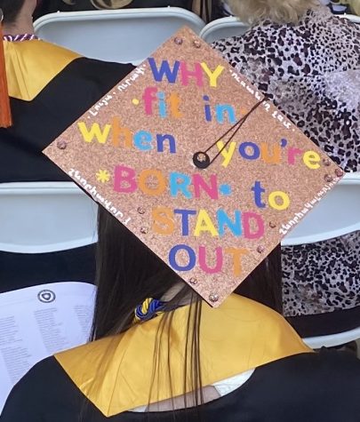 "WHY fit in when you're BORN to STAND OUT" decorated graduation cap coincides with Diacon's speech. 