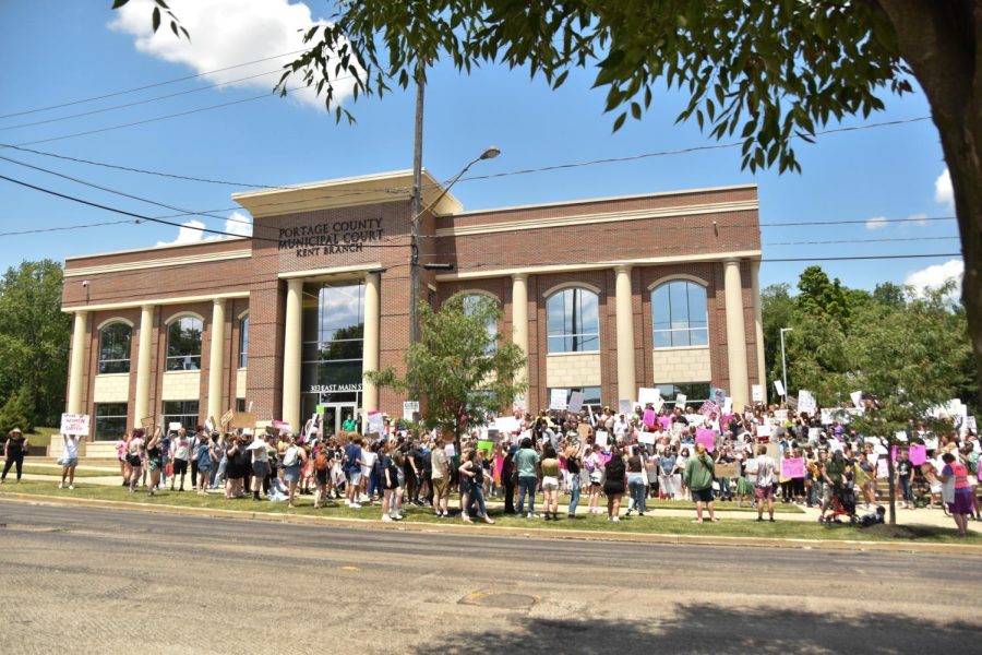 The crowd erupts in a cheer as it makes it to the Portage County Municipal Courthouse, followed by cars honking in support.