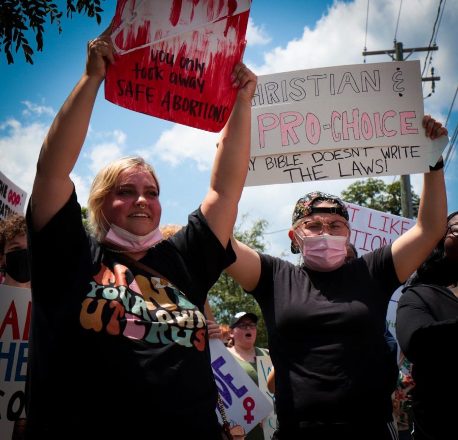 Protesters stand in front of the Portage County Municipal Courthouse, holding their signs high after walking from the K on Risman Plaza during the pro-abortion rights rally at Kent State on Wednesday, June 29.