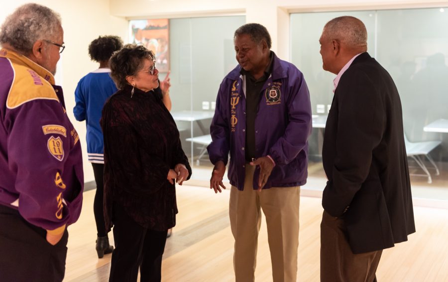 Debra Moore and Hammett Lilly converse in the Uumbaji Gallery. Moore was Timothy Moore's wife and Lilly was one of Moore's fraternity brothers.