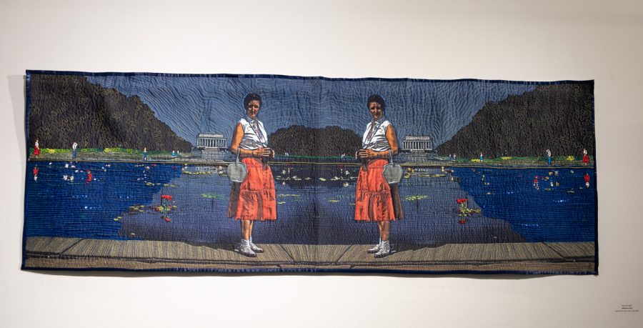 "Reflection Pond" by Mary Ann Tipple is made out of kodachrome slide, cotton and silk ribbon. Tipple's artwork showed details of a pond, trees and people in the background.