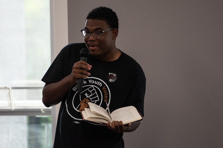 Akii Butler reads a few pages from J. K. Rowling's "Harry Potter" during the second annual Banned Book Reading.