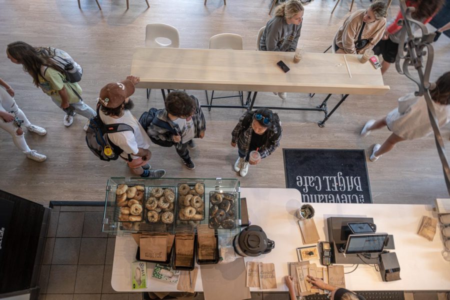 Cleveland Bagel Company customers check out their orders at the register and take a seat to enjoy their coffee.