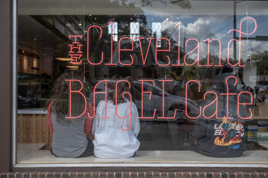 Customers take a seat on the windowsill of the Cleveland Bagel Company.