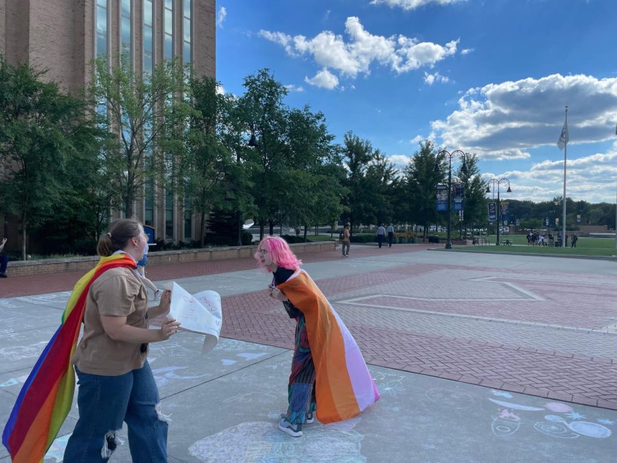 Freshmen Tracy Gavel and Maddie Touve cheer as preachers leave after hours of arguing with students on Risman Plaza.