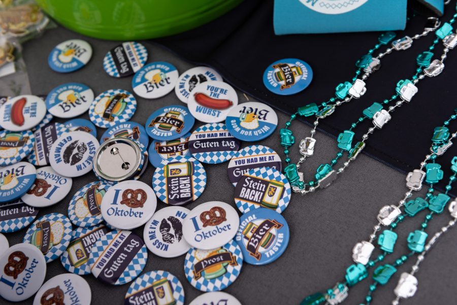 Decorative pins from Oktoberfest are placed on a vendor's table. Each person who approached the table was able to spin a wheel for a chance to win one.