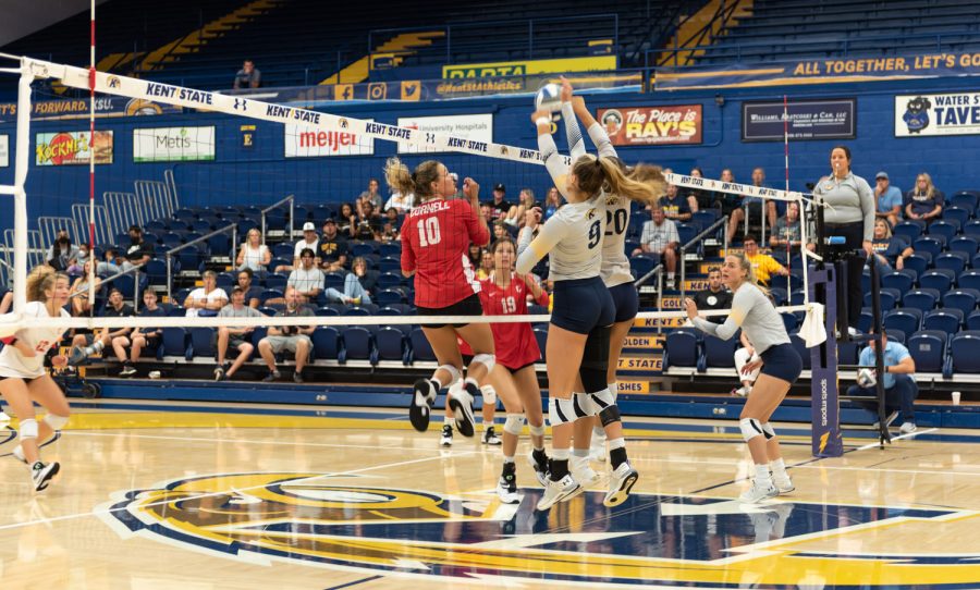 Kent State Women's Volleyball players Taylor Heberle (left) and Danie Tyson jump in the air to block a hit from the Cornell University team. The Kent women played an intense game but were beaten 3-1.