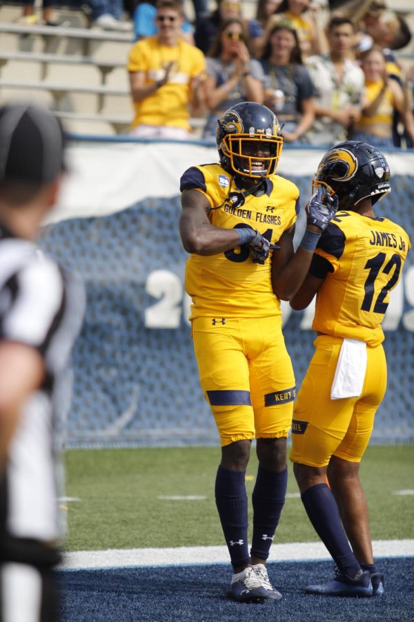 Kent State wide receiver Devontez Walker (left) celebrates with Ray James (right) after scoring a touchdown. 