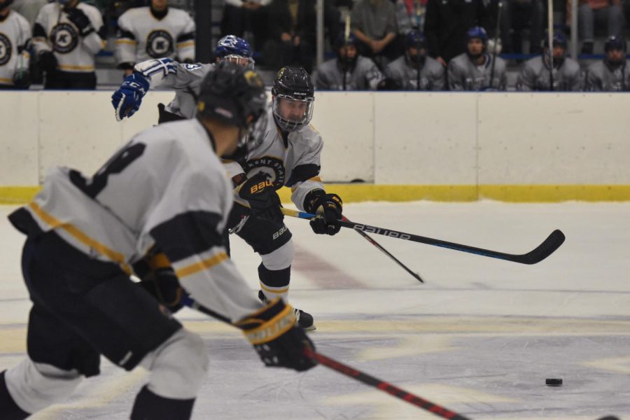 A duo of Kent's hockey team members races the puck down the rink. 