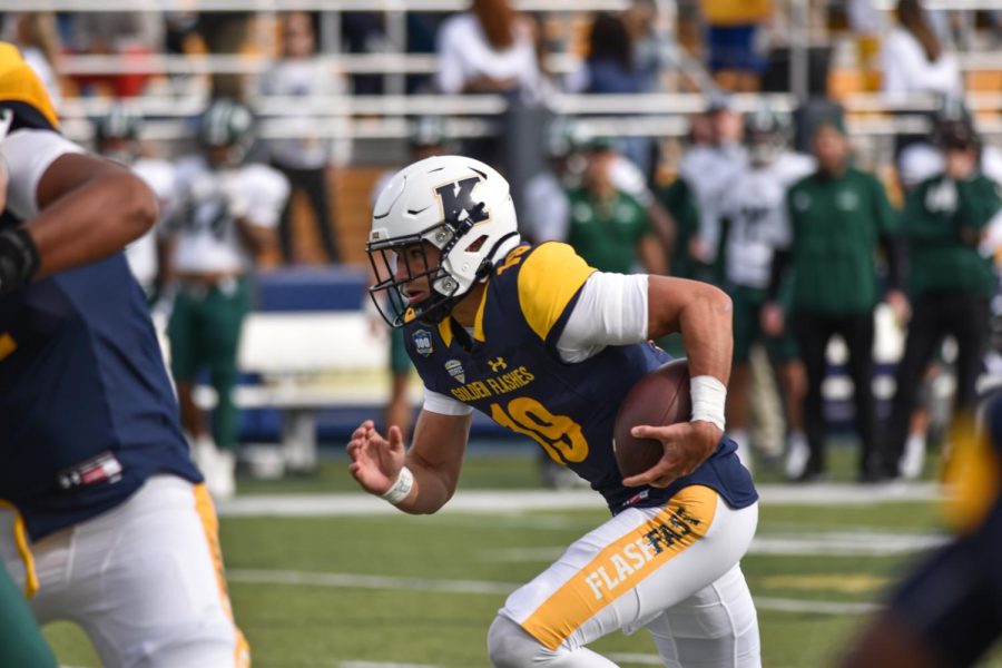 Kent State quarterback Collin Schlee runs the ball downfield.