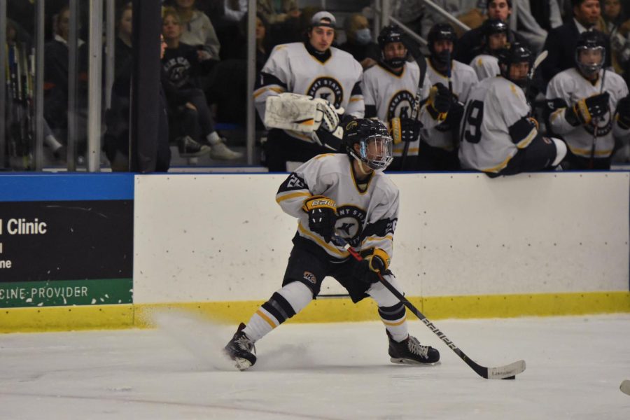 A Kent State hockey team member skids into a turn as he snags the puck from the Lawrence Tech hockey team. 