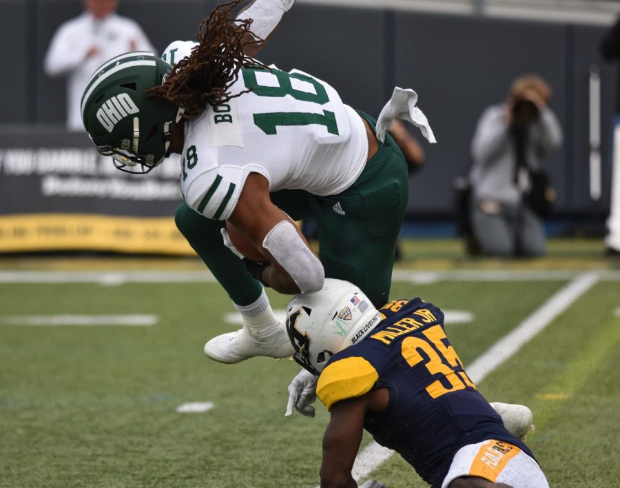Kent State defensive back D.J. Miller, Jr. knocks his OU opponent off of his feet.