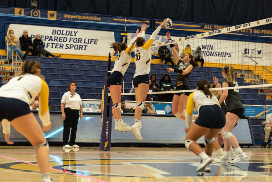 Freshman outside hitter Mackenzie McGuire (left) and fifth-year middle blocker Lana Strejcek block an attack from Western Michigan Oct. 29.