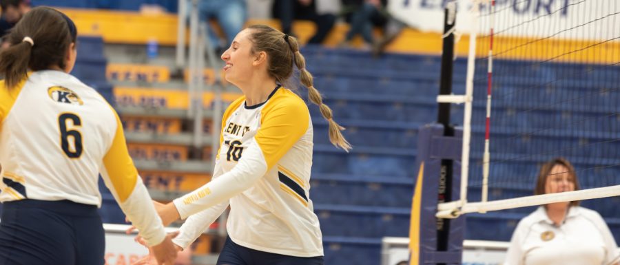 Middle Blocker Lana Strejcek cheers with her team after the ladies won their point from Strejcek's kill.