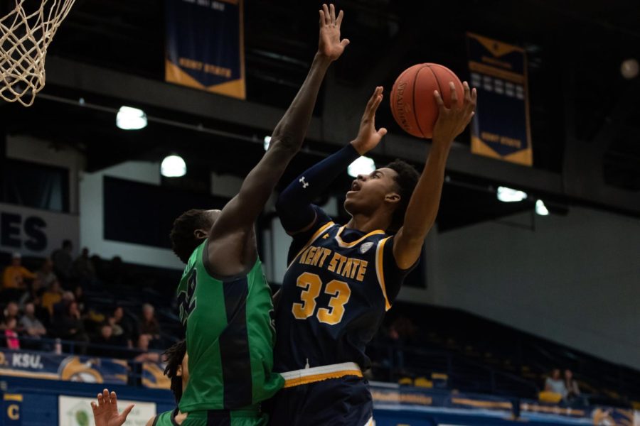 Kent State redshirt senior Miryne Thomas takes a shot as Chicago State's Arol Kacuol attempts to block him. 