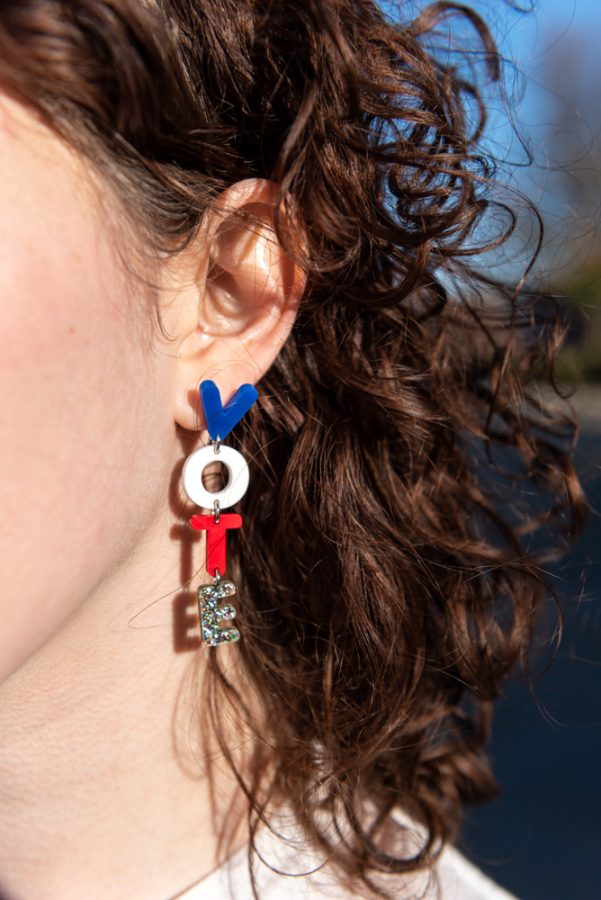 Junior Victoria Bernhardt shows off her voting earring. She was out volunteering for Ohio Democrats at the Student Recreation and Wellness Center.