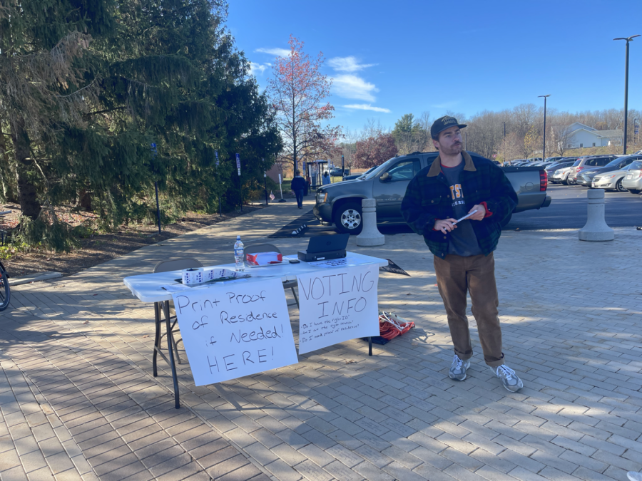 Connor Compton, a worker at the Ohio Democratic Party, stands outside Kent State's Recreation and Wellness Center for students who need a "proof of residence" document printed out. Compton said he would be there all day until the polls close.