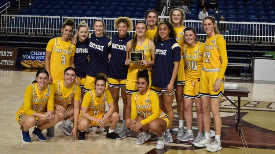 The Kent State women's basketball players hold the Christmas Classic Trophy Nov. 27. The team won the title after defeating Quinnipiac and Southern Illinois.  