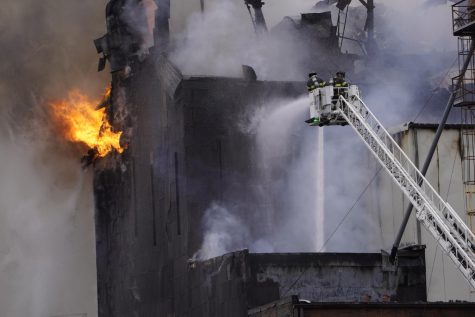 Firefighters spray down the massive fire at the Star of the West mill complex in downtown Kent. More than seven local fire companies responded to the blaze, which began just before 9 a.m. 12/2/22