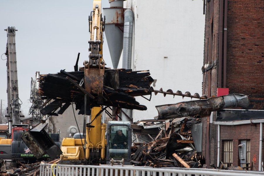 Moving down the train tracks, the operator moves the debris to a separate pile.