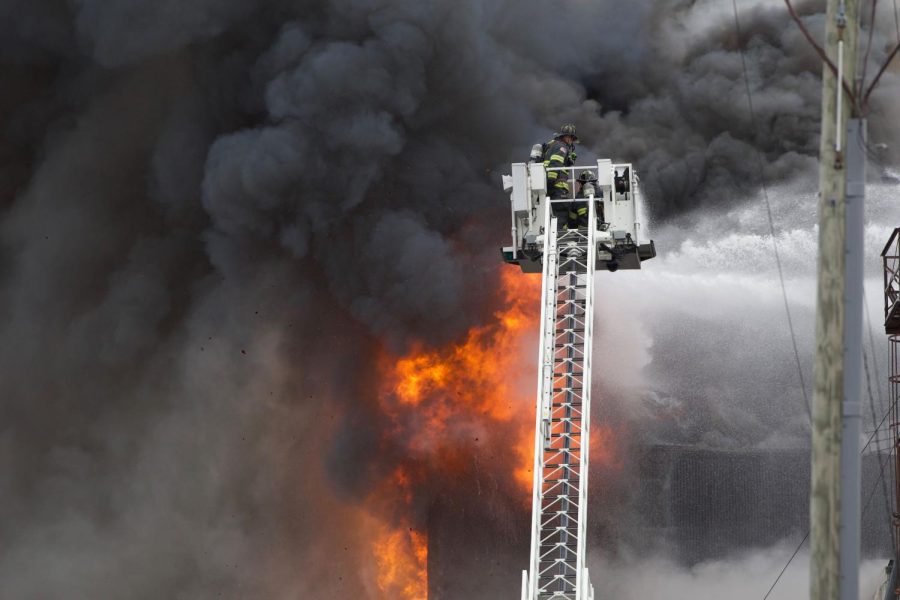 Firefighters rise into the blaze in downtown Kent.