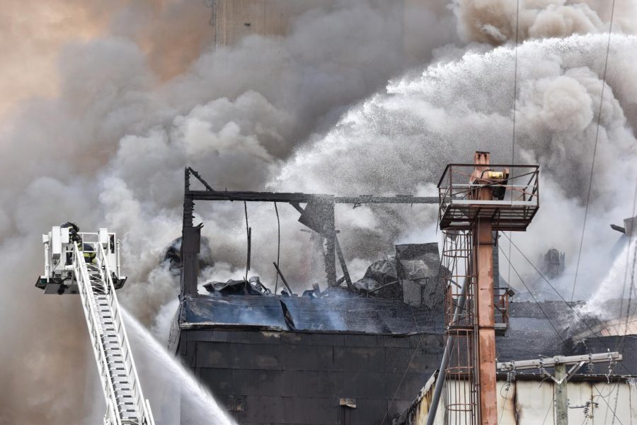 Firefighters douse the Star of the West Mill with water as they work to put out the blaze.