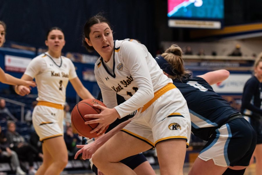 Kent State senior Katie Shumate spins around a Hiram defender as she drives towards the net.