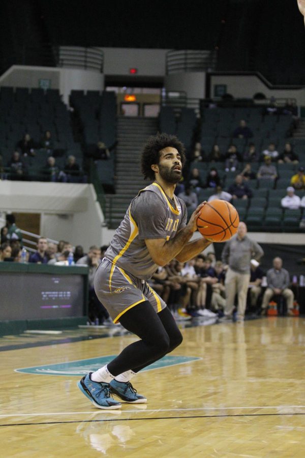 Point Guard Sincere Carry shoots a three in Kent State's 67-58 win over Cleveland State on Saturday afternoon.