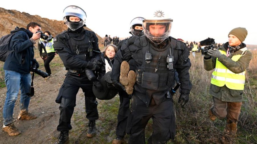 Police carry Thunberg out of a group of protesters and activists and away from the edge of the Garzweiler II opencast lignite mine. Roberto Pfeil/picture alliance/Getty Images