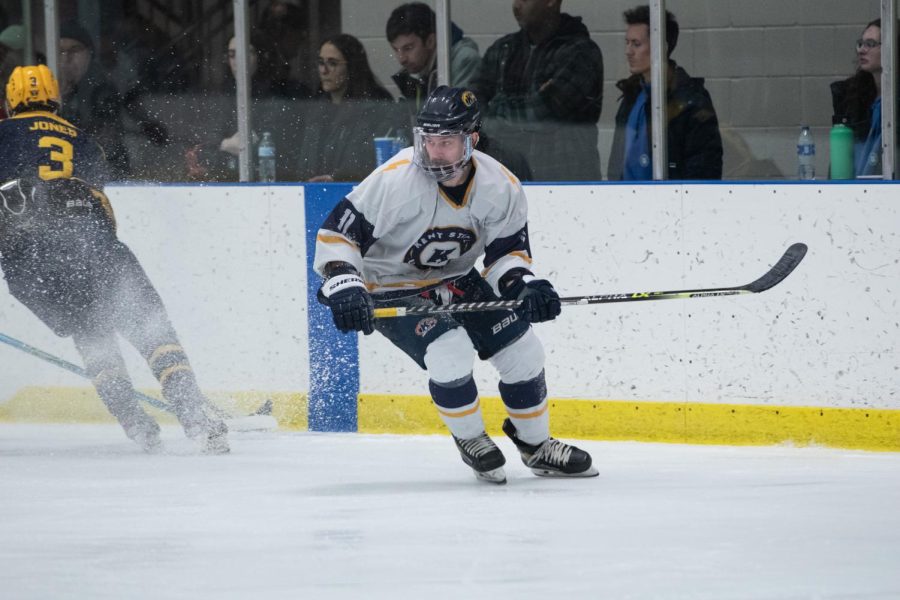 Kent State hockey team member Mitch Gillespie skids into a turn as the puck changes hands during the home game against West Virginia University on Jan. 28th, 2023.