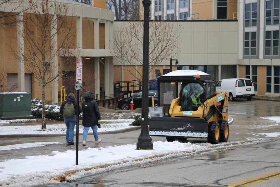 Kent State maintenance clearing the sidewalks outside of student dorms. 