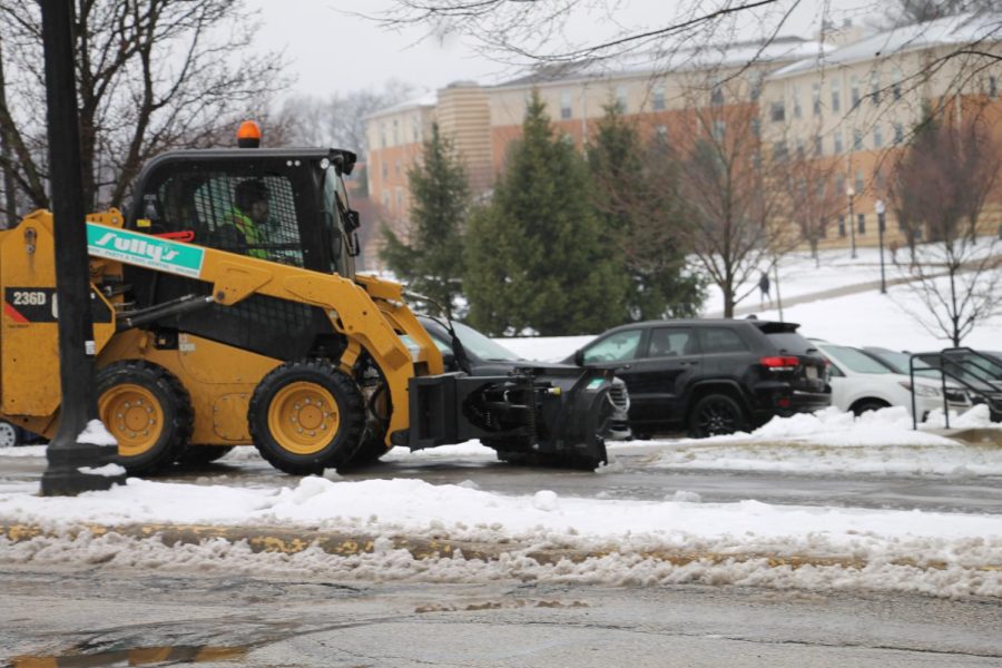 Kent State maintenance clearing the sidewalks outside of student dorms. 