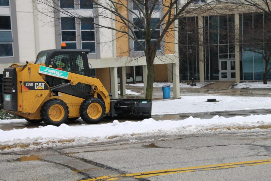 Kent State maintenance clearing the sidewalks outside of student dorms. 