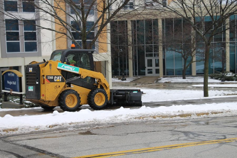 Kent State maintenance clearing the sidewalks outside of student dorms. 