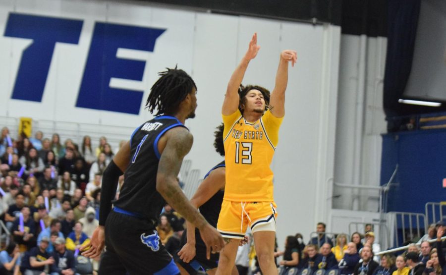 Jalen Sullinger, Kent State sophomore, takes an open shot as Buffalo senior LaQuill Harnet watches from a few feet away.