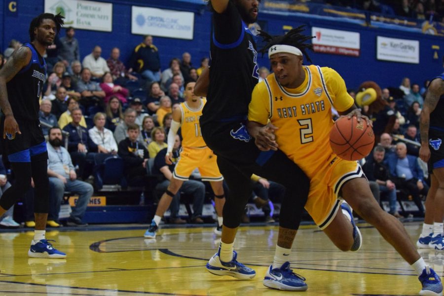 Redshirt Senior Malique Jacobs plows through Buffalo opponent for a layup attempt on Jan. 27, 2022.