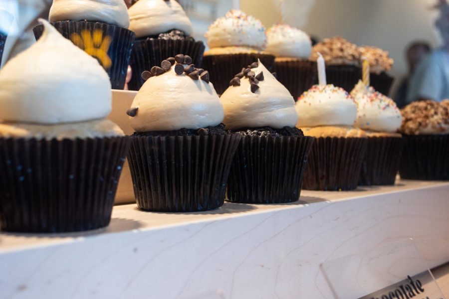 A variety of cupcakes line display shelves at the counter inside Rocco's Cupcake Café on Feb. 4, 2023.