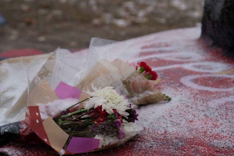 Three flower bouquets placed on the base of the rock Feb. 17, 2023.