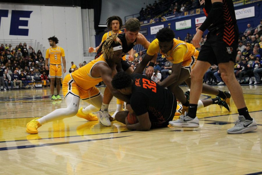 Kent State players dive for Bowling Green senior Gabe O'Neal to gain possession of the ball during the game on Feb. 7, 2023.