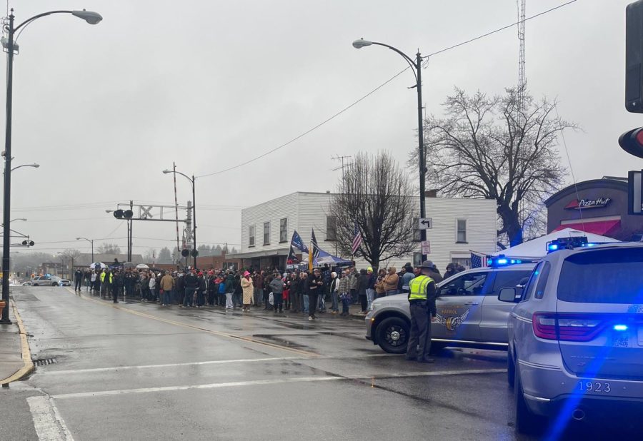 East Palestine residents and visitors line up on North Market Street Feb. 22 in anticipation of former president Donald Trump's visit. Trump and his son, Donald Trump Jr., came to address the Feb. 3 train derailment.